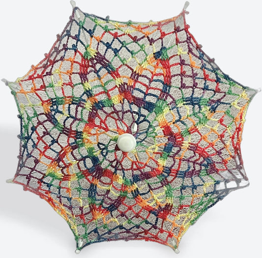 A 12" parasol is open and facing the camera. The canopy is crochet in rainbow variegated yarn and there are lots of rainbows packed in to this daisy pattern. 