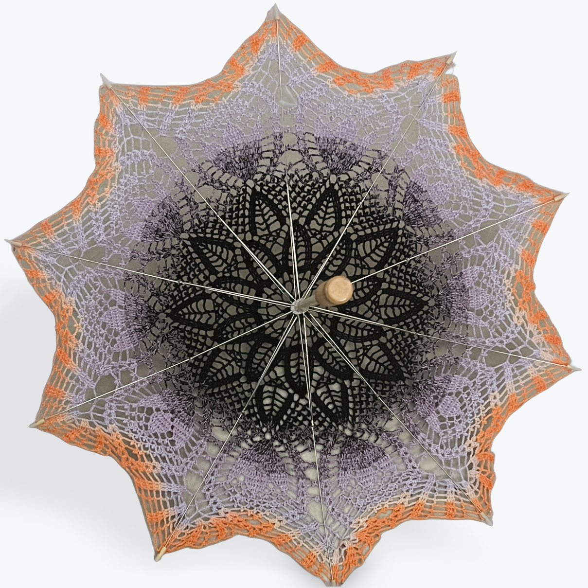 Decorative umbrella with lace-like design on a white background