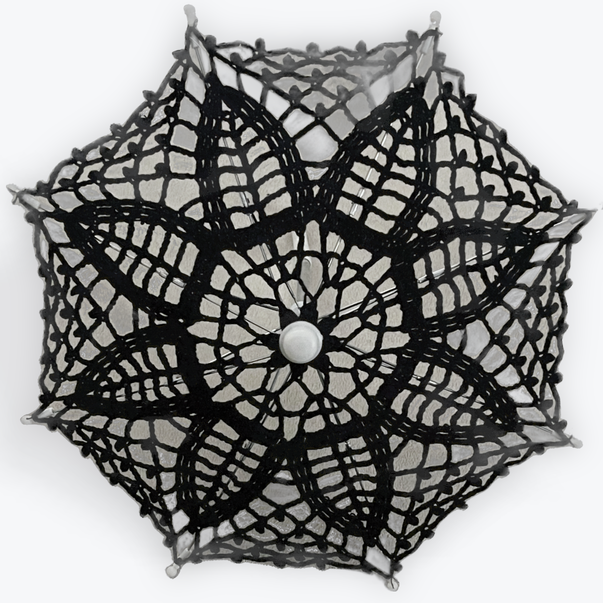 Black lace parasol on a white background is facing the viewer.