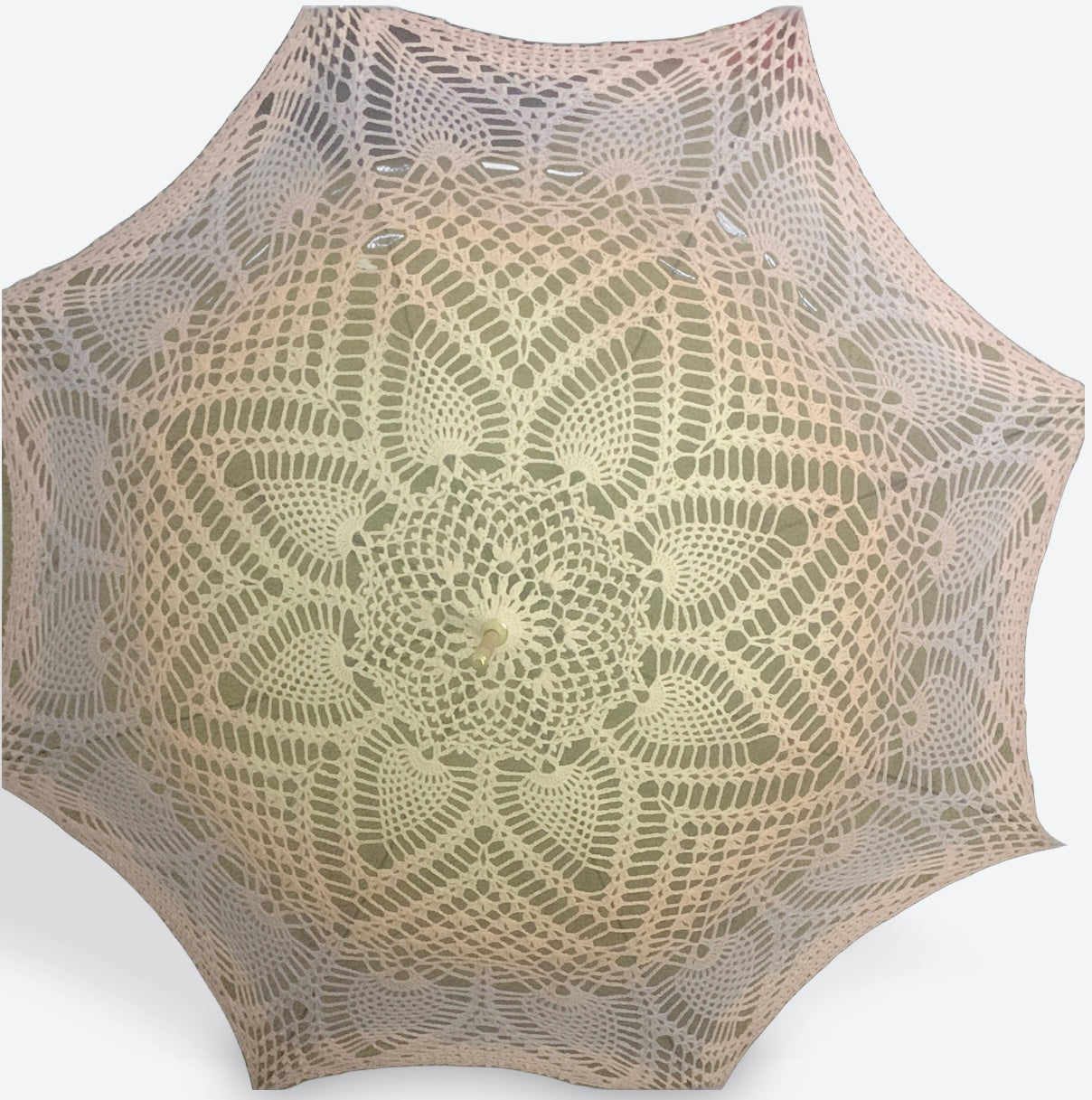 This parasol is a completely custom colorway that begins with pale yellow at the center fading into orange, then purple, then pink at the edge. The pattern begins with picos and leaves and then concentric pineapples. 