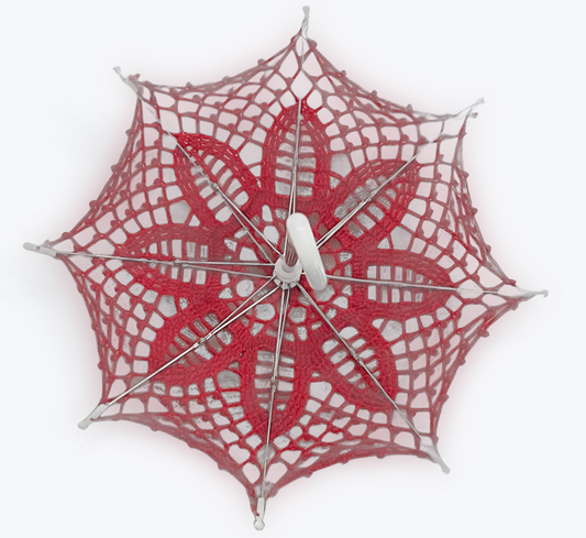 Red lace daisy pattern 12" parasol is open and upside down facing the viewer. The little white handle is coming toward the viewer in this picture. 